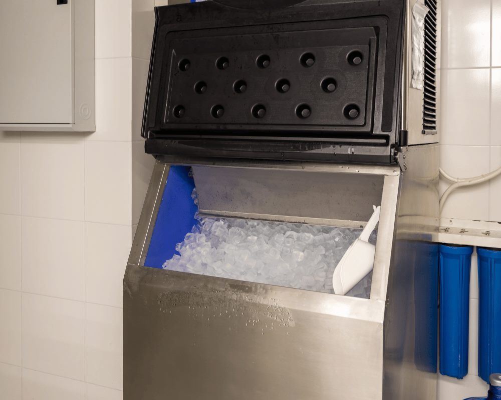 Commercial ice machine with an open bin full of ice